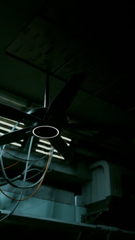 a black ceiling fan in a dark room