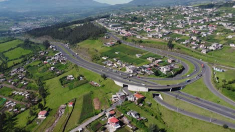 Experience-a-unique-journey-with-this-4K-drone-video,-capturing-the-majesty-of-the-Pan-American-Highway-at-the-iconic-Santa-Rosa-Curve,-Cutuglahua-parish,-Mejía-Canton