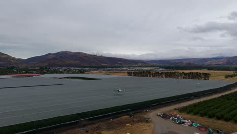 Helicopter-flies-low-over-Cromwell-orchards-in-the-rain-to-dry-the-cherries