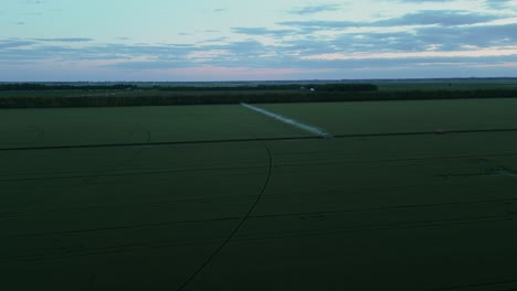 scenic view of an expansive farmland at sunset. aerial drone shot