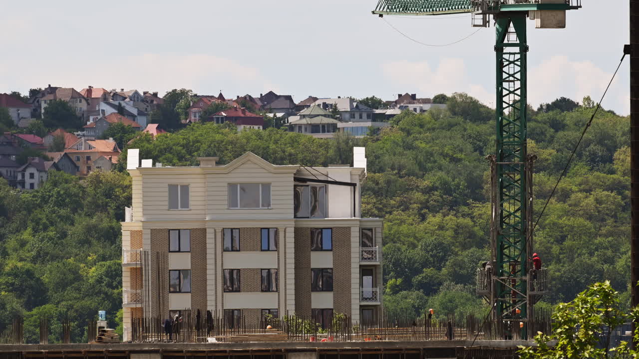 Time lapse of a construction site with workers building near a residential area