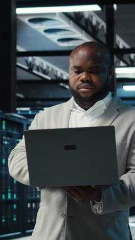 vertical video data center engineer analyzing equipment performance, resolving technical issues