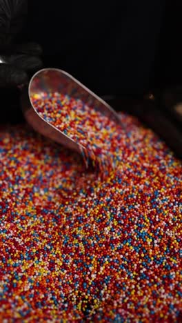 colorful sprinkles being scooped