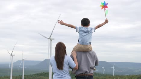 concept of progressive happy family enjoying their time at the wind turbine farm