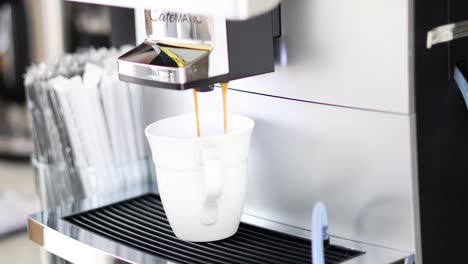 automatic espresso machine dispensing coffee into cup