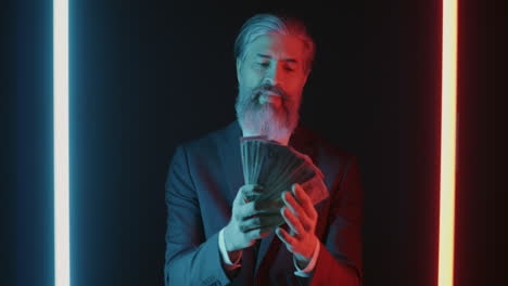 businessman with money under neon light