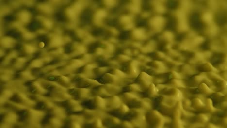 olive green liquid splashing
