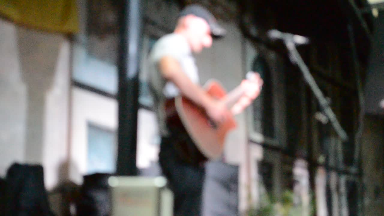 The musician, out of focus. Lviv, Ukraine. The musician plays the guitar in cafe