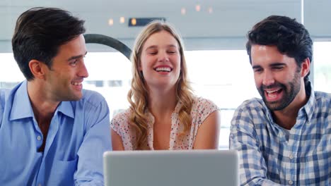 Friends-interacting-using-laptop