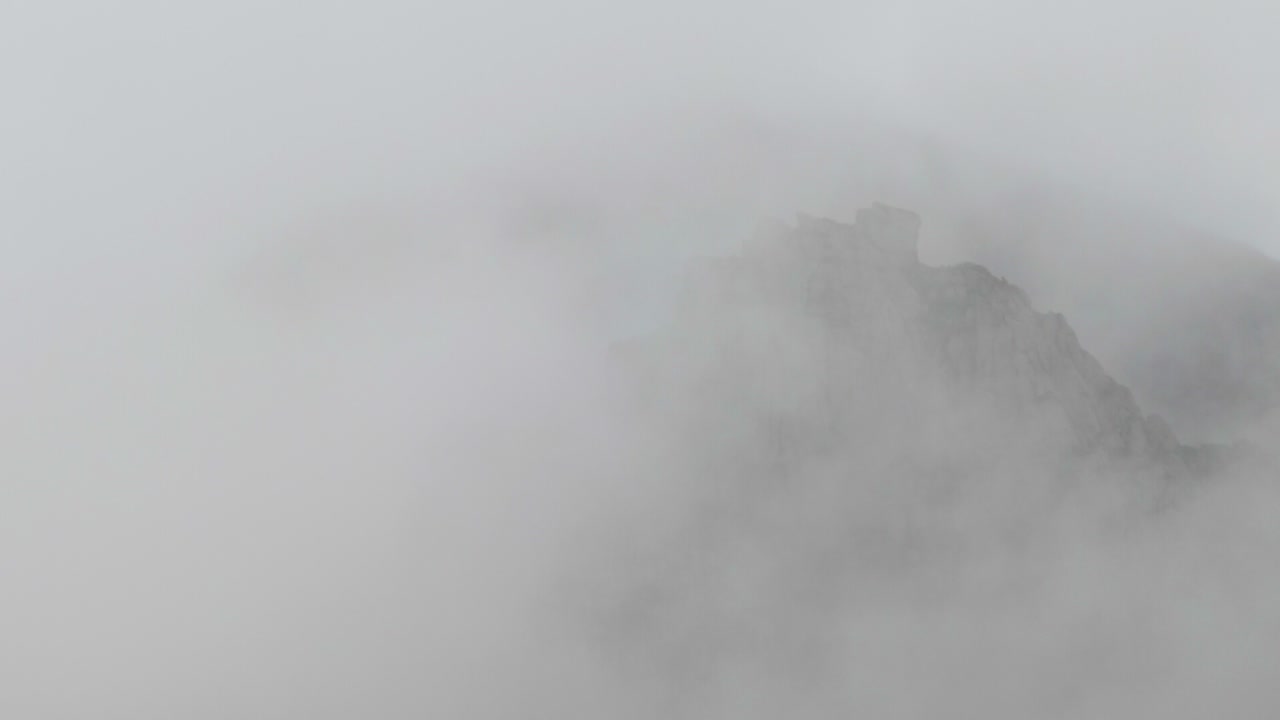 Top of a mountain hidding behind the clouds.