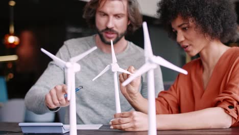 two young engineers discuss wind turbine