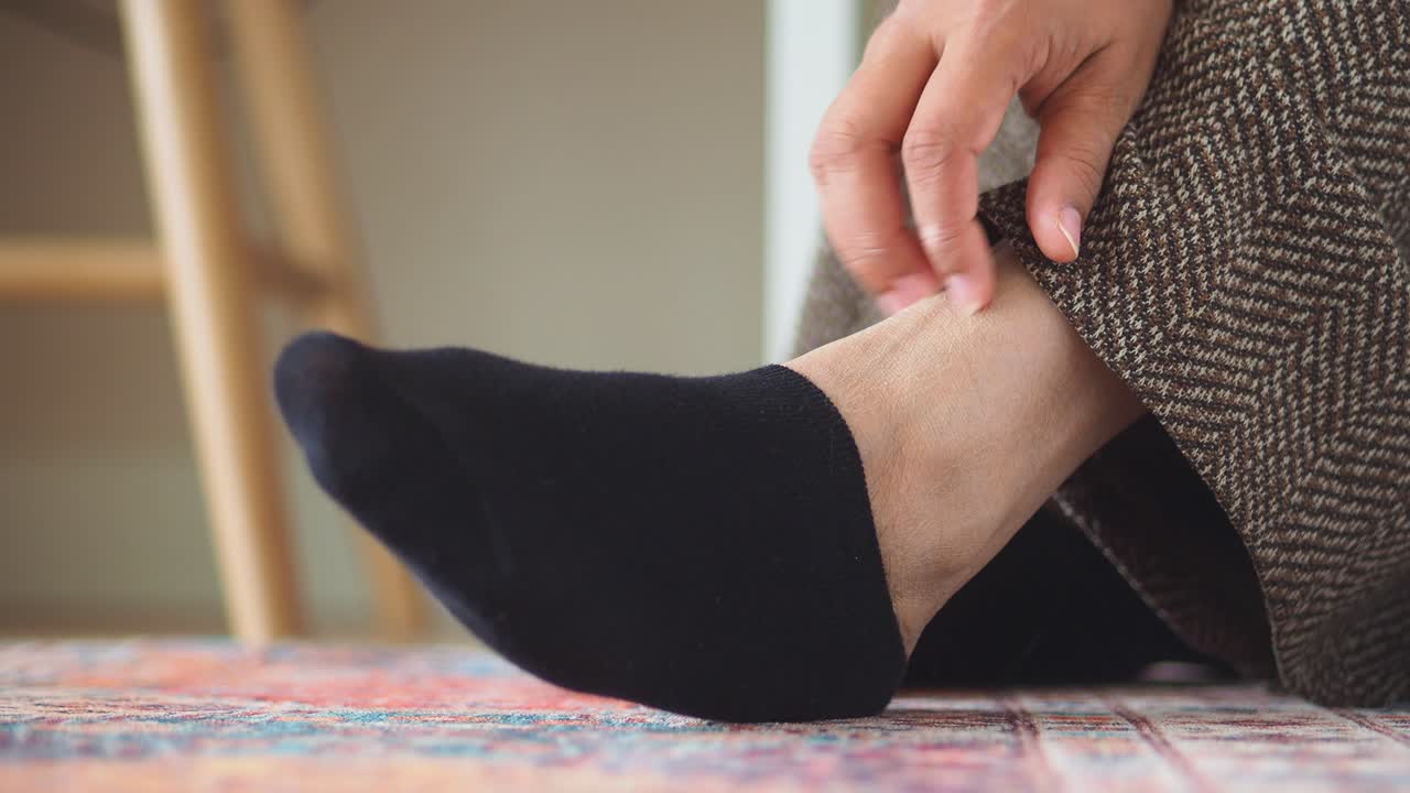Close-up of a foot in a black sock