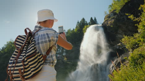 Traveler-Takes-Pictures-Of-Majestic-Steinsdalsfossen-Is-A-Waterfall-In-The-West-Of-Norway-4k-Video