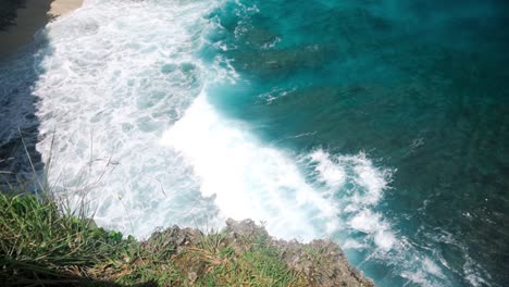 top view of crashing waves and white wash on broken beach, nusa penida, bali