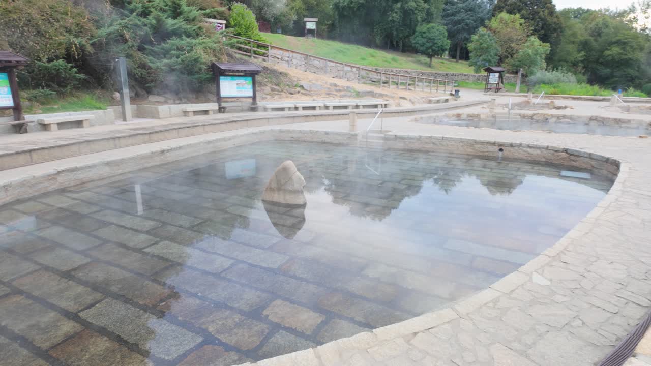 Establishing shot of Muiño da Veiga thermal baths in Ourense, Galicia, Spain