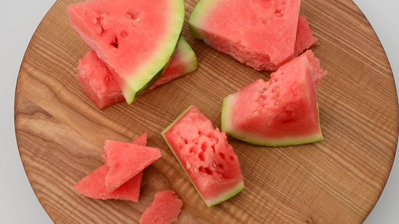 Shooting of a watermelon on a kitchen board. Shooting in the movement
