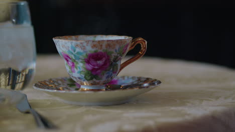 Close-Up-of-Tea-Being-Poured-into-a-Beautiful-Floral-China-Tea-Cup