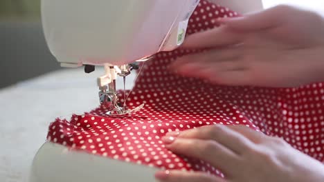 woman sewing at home. close up of working sewing machine at home