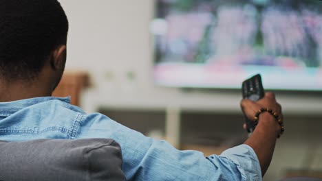 rear view video of man watching tv