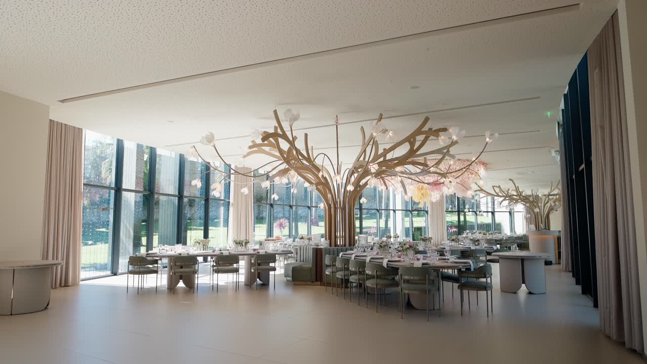 Event venue with floral chandelier and modern decor by large windows