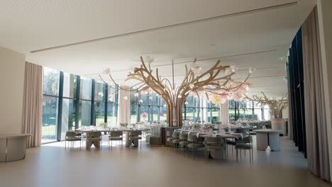 event venue with floral chandelier and modern decor by large windows