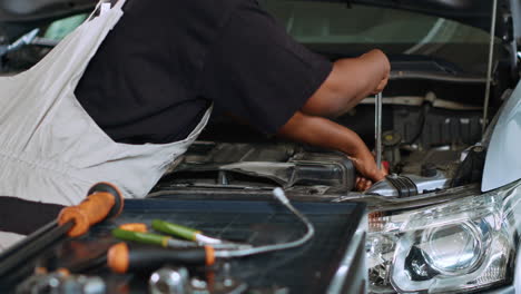 technician in garage using torque wrench