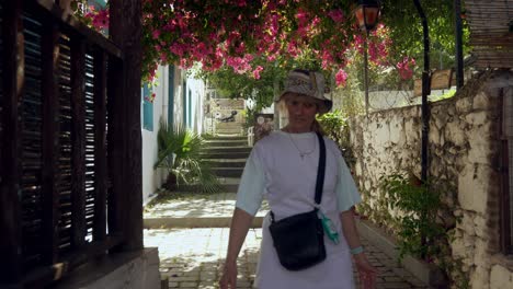 female tourist explores narrow cobbled streets of kas mediterranean town.