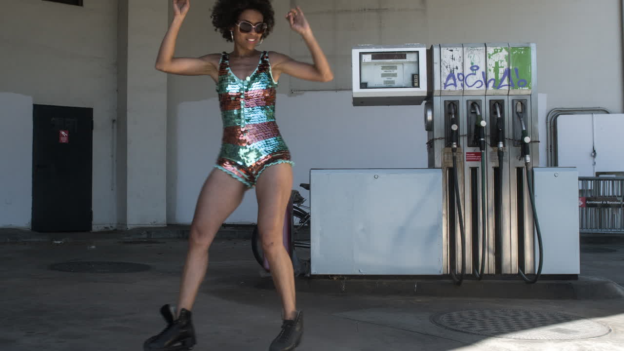 cool roller skating woman dances and skates outside in an urban setting