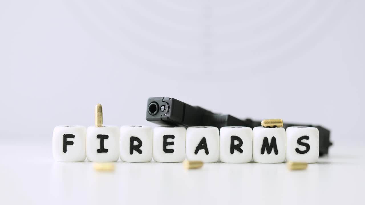 A pistol and bullets with the word firearms written out