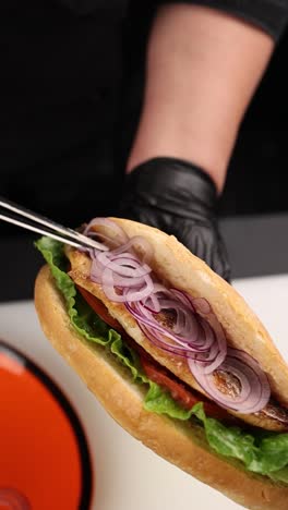 chef preparing a fish sandwich