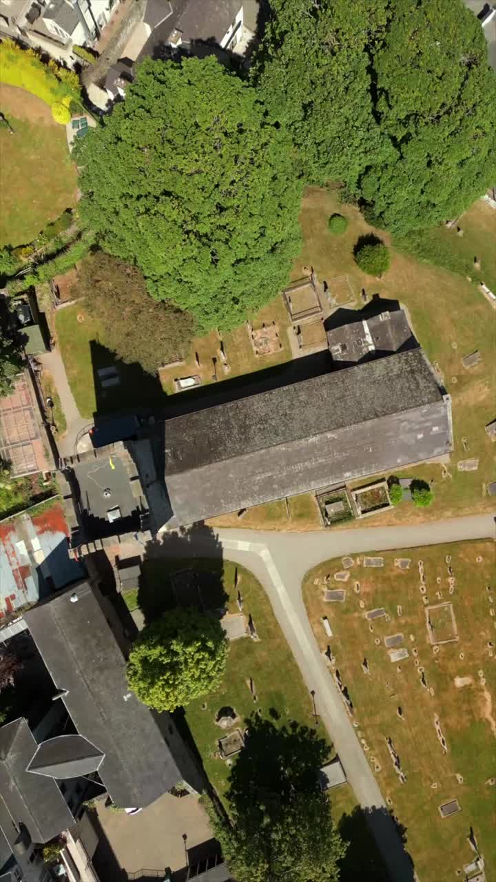 Rising overhead social ratio aerial video of St Michael's Church in Carlingford in County Louth, Ireland. Filmed in 1080x1920, 60FPS and with Rec709 color