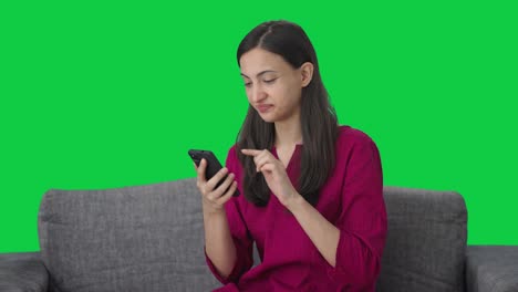 Tired-Indian-woman-using-a-phone-Green-screen