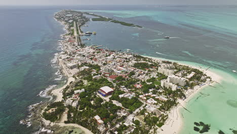 Isla-Mujeres-Mexico-Aerial-v7-birds-eye-view-of-island-paradise,-Playa-Norte-with-white-sandy-beaches-and-Mia-Reef-resorts-surrounded-by-crystal-clear-sea-water---Shot-with-Mavic-3-Cine---July-2022