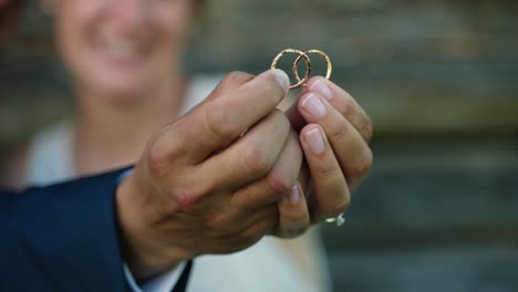 Bridal-couple-holding-rings-together