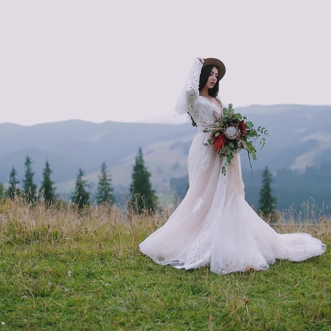 . Beautiful bride in white dress. Young bride posing on the mountain hills