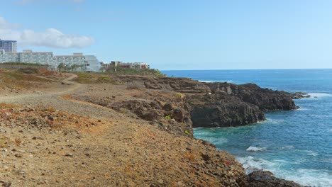 Establishing-shot-of-Costa-Adeje-in-Tenerife,-sea-cliff-and-buildings-resort