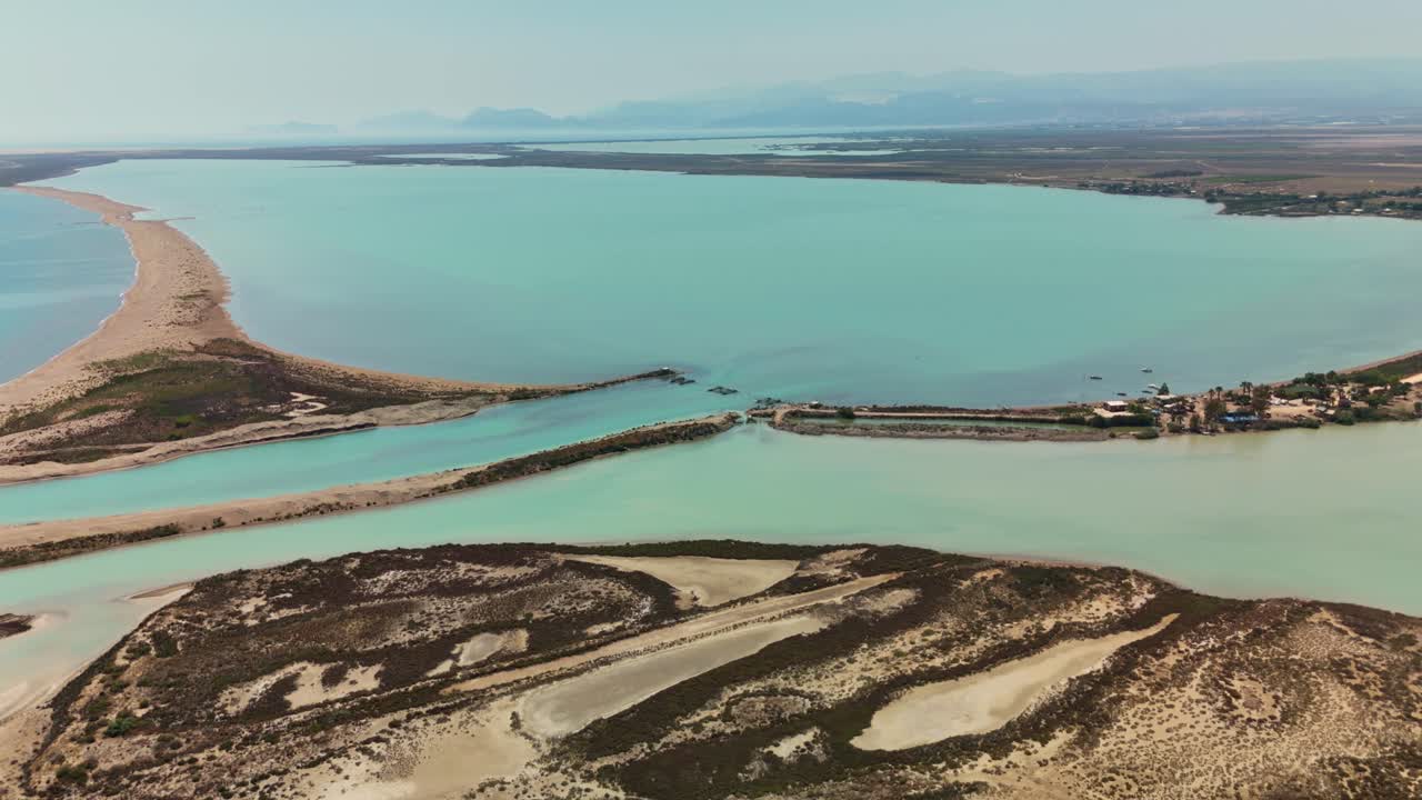 Aerial view of lagoon with sandy shores and turquoise waters, serene vibe