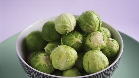 Top-View-of-Fresh-Brussel-Sprouts-rotating-on-blue-background