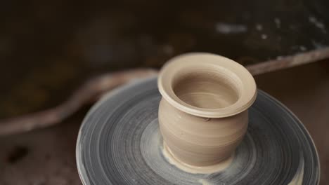 the potter makes a jug of clay. ceramist. a man makes a vase on a potter's wheel