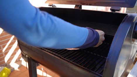 Placing-a-large-Salmon-fillet-on-the-grill-while-cooking-on-a-wood-pellet-grill-during-the-evening