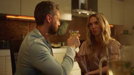 Attractive-woman-and-man-sitting-on-kitchen.-Husband-and-wife-talking-at-table