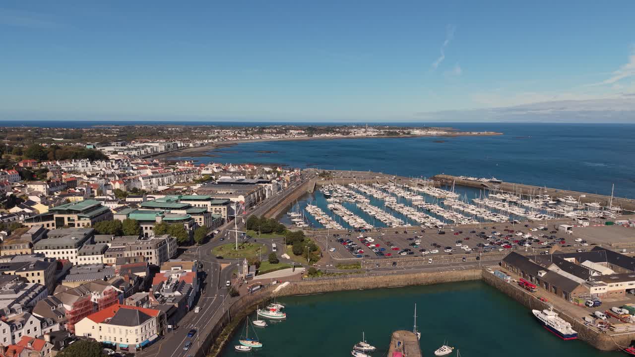 Flight over careening hard and Cambridge Berth St Peter Port Harbour Guernsey over QEII Marina and Salerie Corner on sunny day with blue sky calm sea and views over Belle Greve Bay towards St Sampson