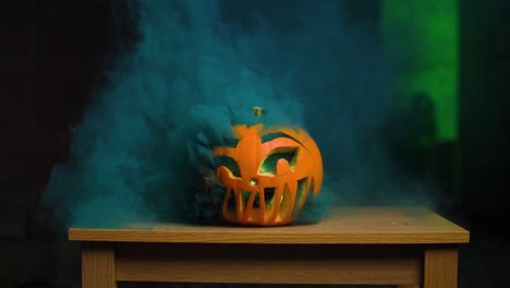 Carved-pumpkin-for-Halloween-with-colourful-and-thick-smoke-coming-out-through-the-holes-in-slow-motion