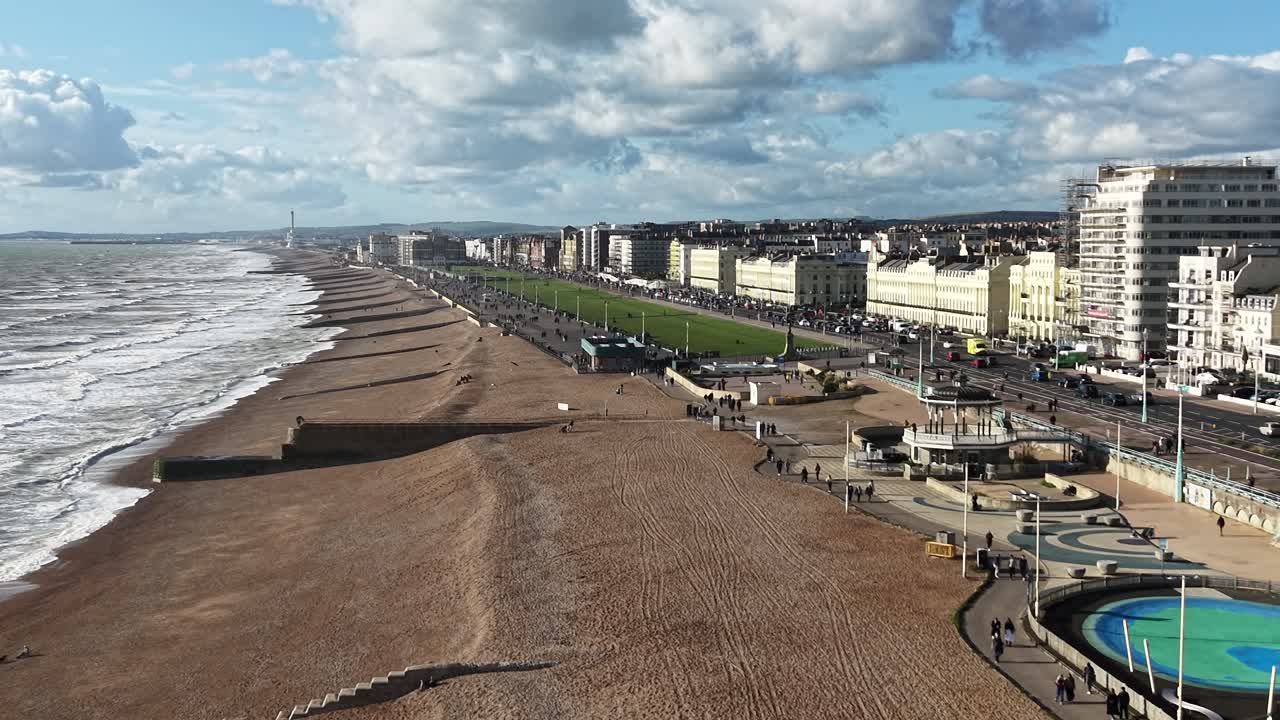 Brighton and Hove UK busy promenade drone,aerial reverse shot