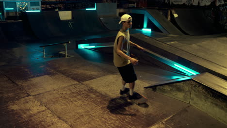 Young-friends-training-trick-on-scooter-and-skateboard-at-urban-environment.