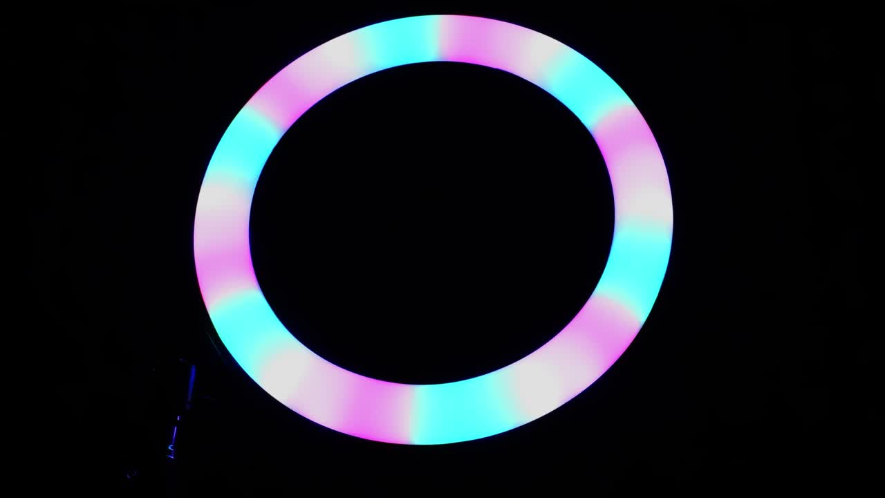 lámpara rgb de anillo luminoso. luz multicolor en una habitación oscura, primer plano.