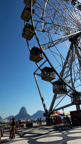ferris wheel with sugarloaf mountain in rio de janeiro