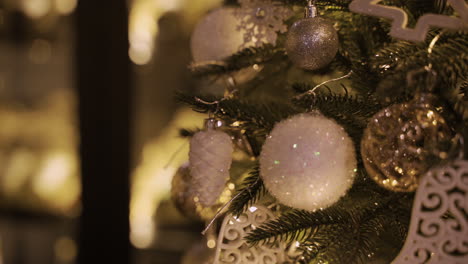 close up view of a christmas tree with white and silver christmas decorations