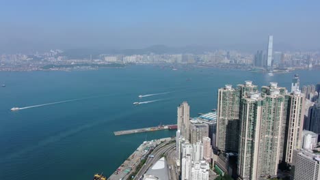 Hong-Kong-bay-and-skyline-with-skyscrapers,-high-altitude-wide-shot