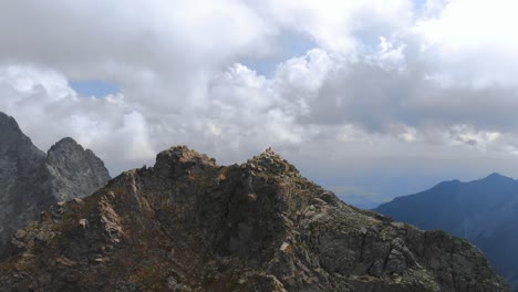 aerial mountain summit dolly out revealing beautiful mountain range landscape and epic view